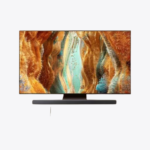 An angled view of the Samsung 43Q65D 4K QLED Smart TV on its stand, displaying a vibrant, abstract, liquid-like image. An angled view of the Samsung 43Q65D 4K QLED Smart TV and soundbar mounted on a wall, displaying a vibrant sunset over a field of horses. A Samsung 43Q65D TV shows a soccer game with an on-screen chat panel, and a phone displays the same screen. The Samsung 65QN70F QLED TV sits on a low stand with a soundbar, displaying abstract, colorful canyon art. Product Page | Mymensign Branchalarm Ramadan Deal Samsung 65QN70F 65" Neo QLED UHD 4K Smart TV (Unofficial)